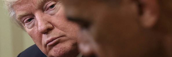 Donald Trump looks at Barack Obama